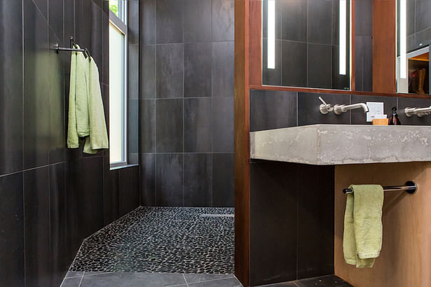 Pebble tile provides a textural floor for the shower.