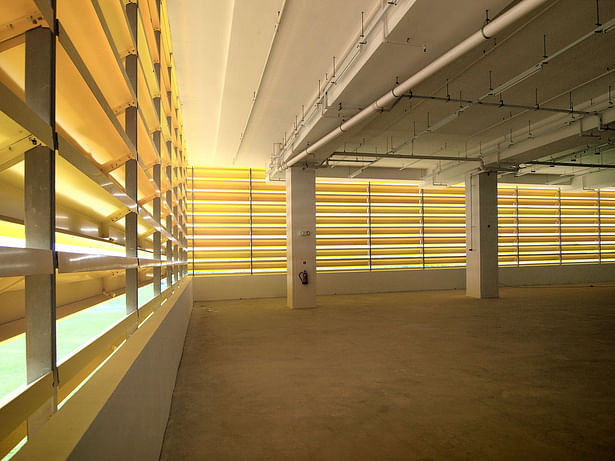 Natural light floods the internal spaces of the factory