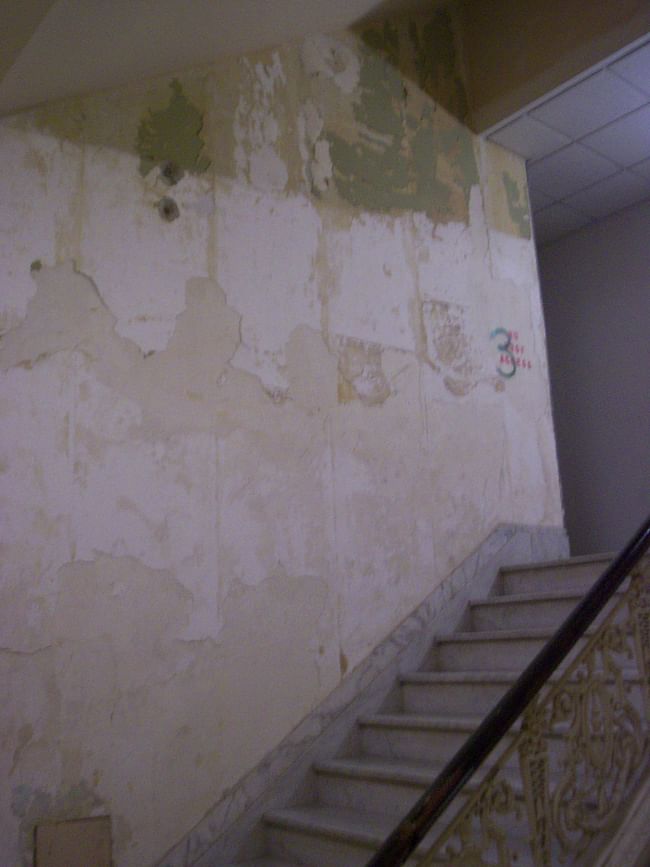 A view of a stairwell in the former Secondary (Southern) Staircase of the Bellevue-Stratford showing the degradation in the forms of heavy water damage, broken walls, soiled and stained wrought-iron... Such disgrace to the name of architecture and artistic applied arts!