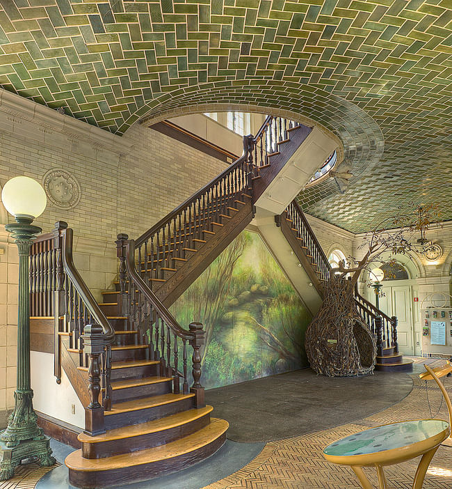 The Boathouse in Prospect Park in Brooklyn is an example of how the Gustavino Company offered their design 'suggestions' to the arthitectural firms, who in turn adopted Guastavino designs with few changes. The Boathouse was designed by the arhitectural firm Helmle and Huberty. This photograph of the interior depicts an example of a 'flat vault' with an opening for a staircase. Photo © Michael Freeman. Courtesy of the Museum of the City of New York 