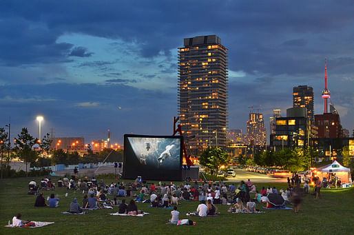 A community movie night on the south lawn at Corktown Common overlooking the downtown skyline. West Don Lands. Toronto, Ontario, Canada. Photo Credit: Nicola Betts.