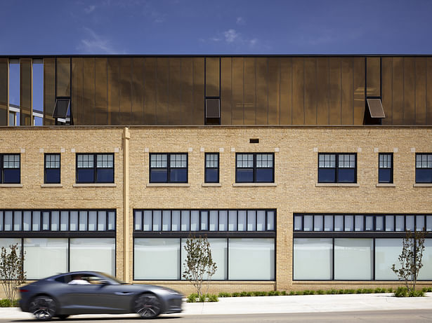 South elevation showing the renovated 1924 building and the new gold glass addition. Note the triangular downspouts.