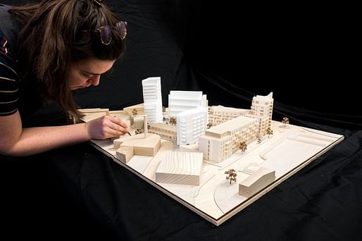 Architectural Assistant Ellie Sampson of Haworth Tompkins working on the Central Middlesex Hospital housing development model. Image courtesy of Fred Howarth/Courtesy of AJ