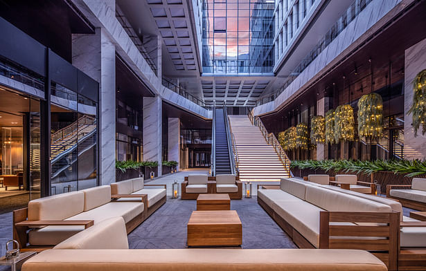 Spotlights are placed above the leisure area of the atrium to simulate the moonlight, creating vacation vibes by One Thousand Degree Visual