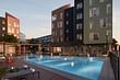 Outdoor pool and building exterior at The Eddy. Image courtesy of QuallsBenson