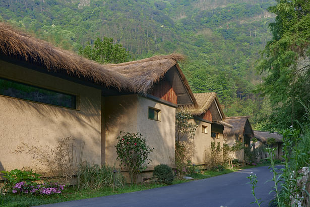 imitated rammed earth thatched cottage