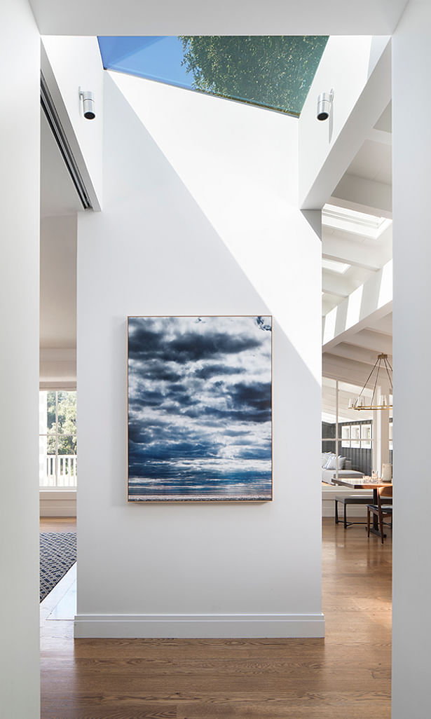 A dividing wall between the living room and kitchen is the perfect showcase for artist Eric Cahan's Sky series print.