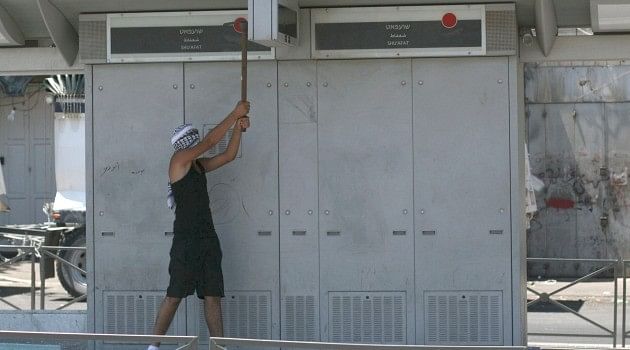 Palestinian youth attacking a light rail station in Jerusalem. Image via the Jewish Daily Forward