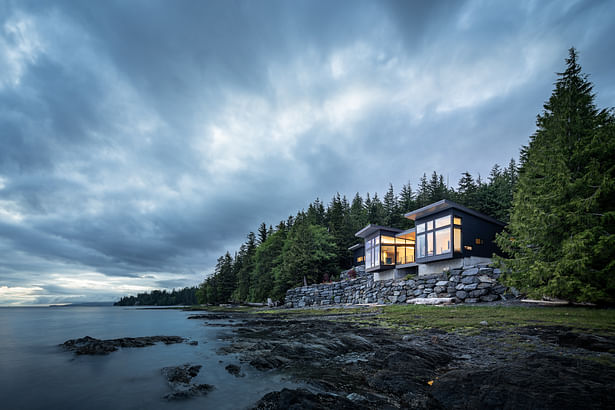 This home stands at the edge of the Tongass Narrows in Ketchikan, Alaska. Two shed roofs angle slightly away from each other, directing views to the wilderness beyond. Andrew Pogue Photography