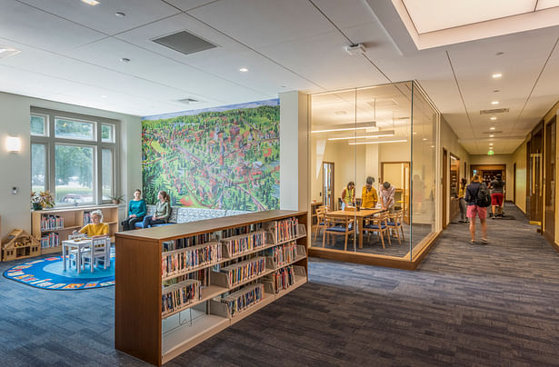 The reconfigured space near the main entrance breaks down traditional barriers between library functions, with a children’s area abutting a glassed-in space that serves as the Archives and Special Collections and Knafel Map Collection Reading Room. The space can also be used by students for quiet study. Photo credit: Peter Vanderwarker
