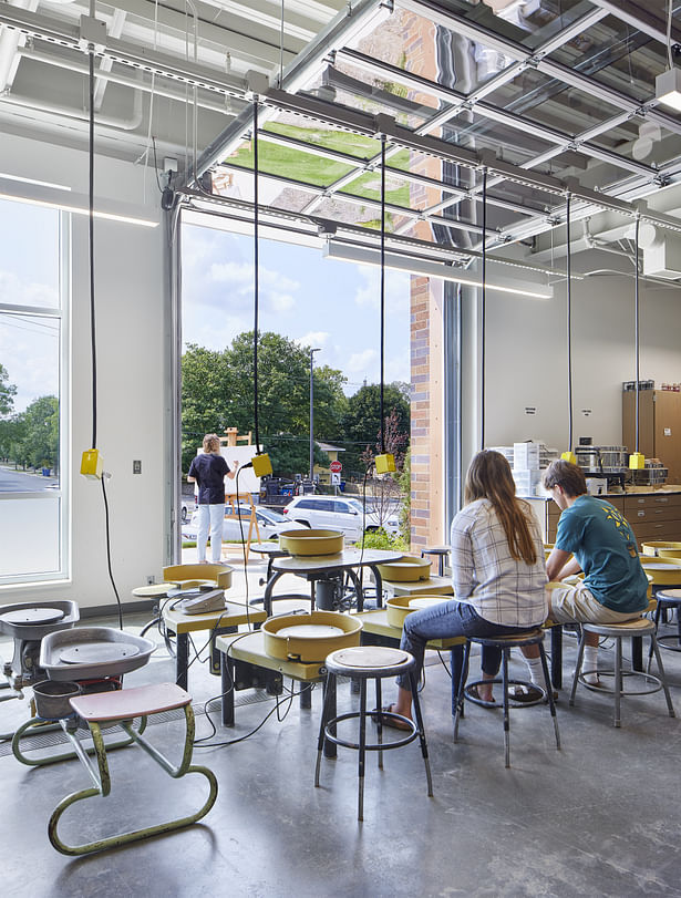 Art rooms with indoor/outdoor connection through glass filled garage doors.