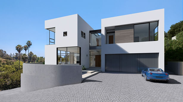 The entrance to the house is a transparent gap between two wings of the house. To the left is the formal living area on the ground floor and the master bedroom above. To the right are the master closets over a three car garage.