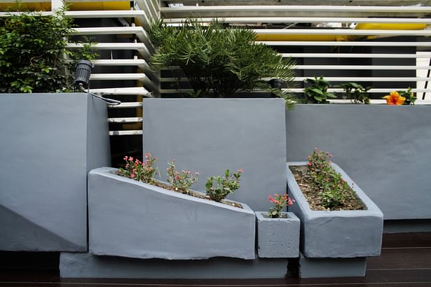Customized concrete planters have been installed strategically in different pockets around the garden.