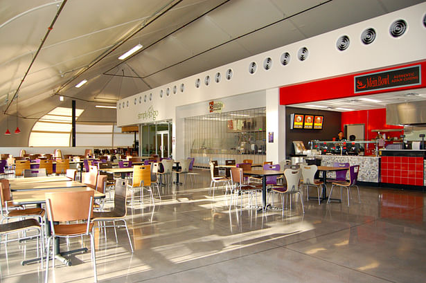 daylight floods the space, where conventional construction holds food service functions