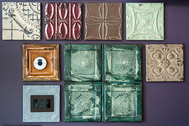 Reception work desk. Electric switch and thermostat blended-in the repurposed tin ceiling decorative element.