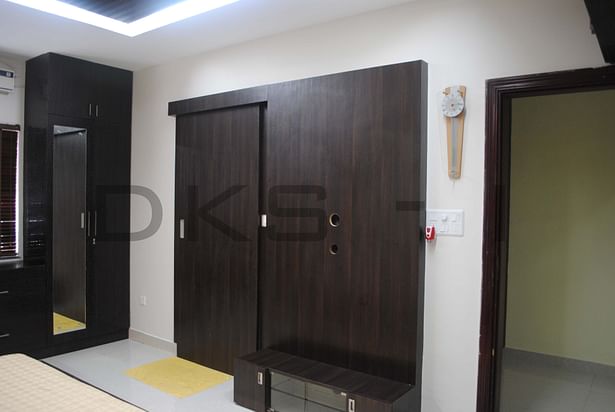 Master bedroom - TV panel with sliding door for rest room