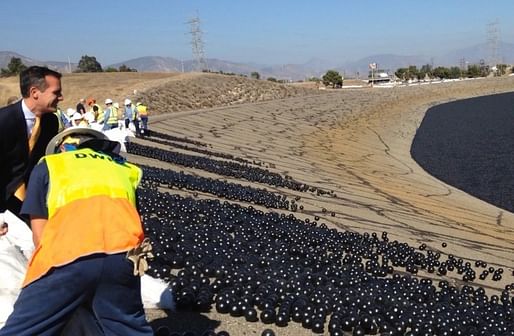 LA Mayor Eric Garcetti helps pitch 20,000 shade balls into the LA Reservoir. Image via atlasobscura.com