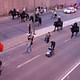 A protester carrying a red flag is followed by policemen on horseback in Montreal in 2012. Credit: Nicholas Korody