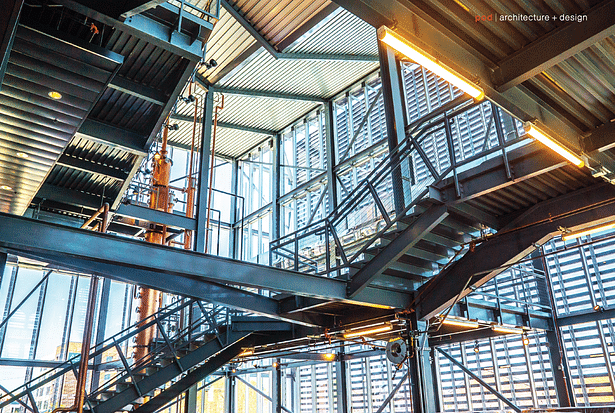 A grand staircase leads through the Manufacturing Atrium. The 48-foot copper still is always in view.