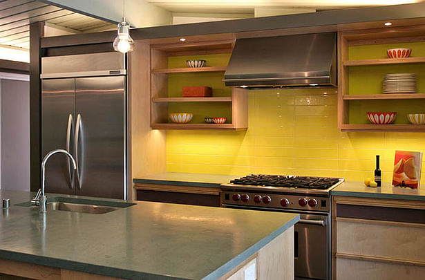 Concrete countertops and plywood cabinetry, bold color all are a nod to the Mid Century style