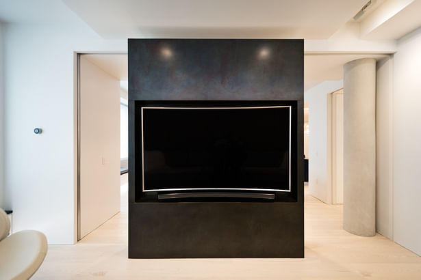 Glass Doors Pocket into the Black Steel Volume to Separate the TV Room from Living Space