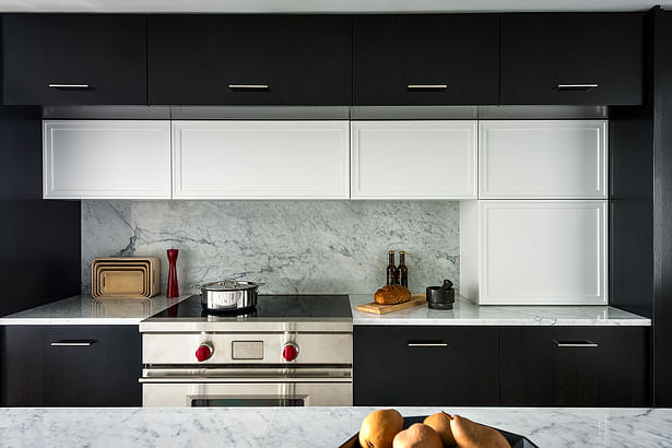 Contrasting mill work highlights the cooking surface in the open concept kitchen.