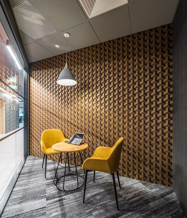 The bold, fresh, geometric-patterned wallpaper with a calming symmetry helps to define and liven up this small meeting room with an added dimension and polished cohesion.