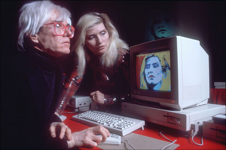 Andy Warhol demonstrating the Amiga PC in 1985. Image via Wikipedia Commons.