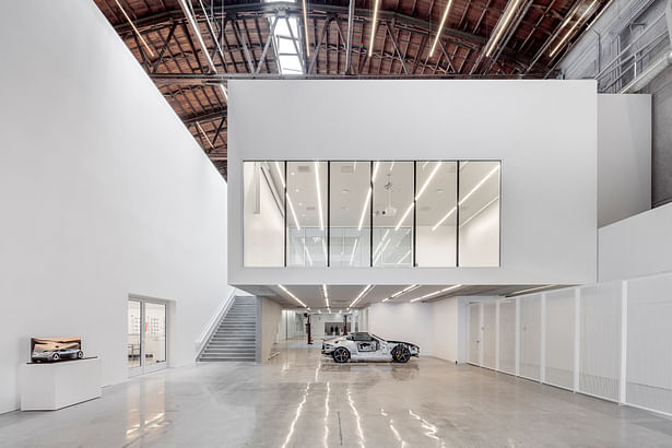 This image from the Fabrication Lab on level one features a “cut away” Jaguar F-Type and shows the hovering flexible lecture / gallery space above. | Credit: Joshua White (jwpictures.com)