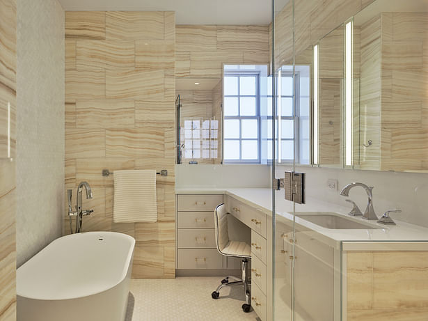 Modern touches extend to the apartment's four full baths. Each includes bold design statements, including floor-to-ceiling onyx tiles and full slabs of Zebrino marble. 