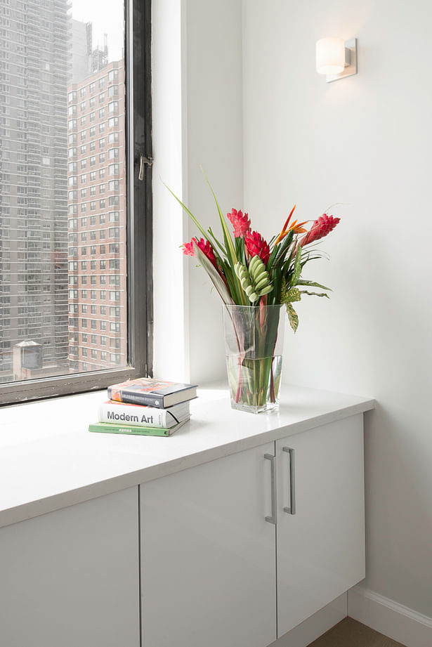 Corner detail showing the built in radiator cover unit using milestone by consenting and painted wood cabinets