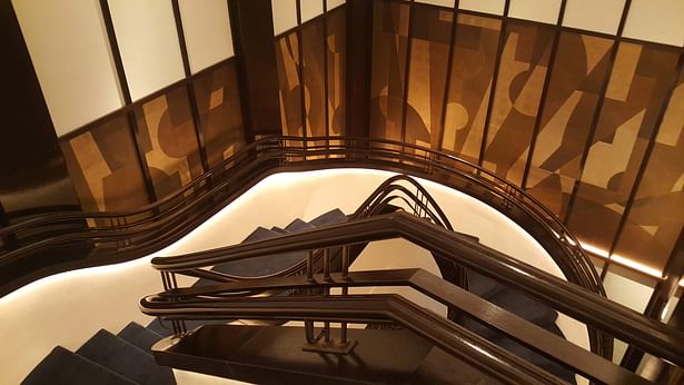 Continuous curved wooden handrail in a restaurant in New York, USA 