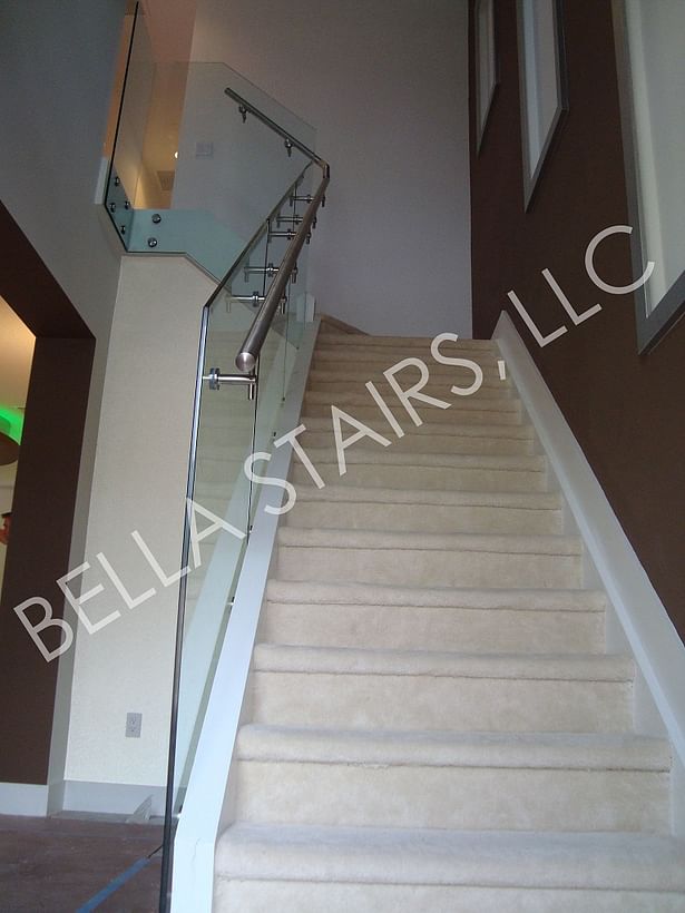 Glass railings & brushed stainless steel elements transform this residential stair.
