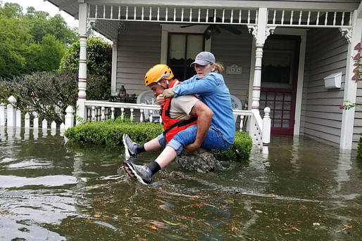 A Texas National Guardsman carries a resident from her flooded home following Hurricane Harvey in Houston, Aug. 27, 2017. Army National Guard photo by Lt. Zachary West