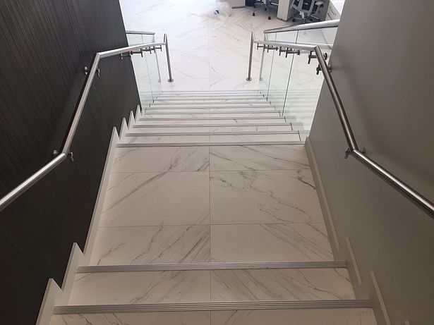 Glass railings & brushed stainless steel elements transform this commercial stair.