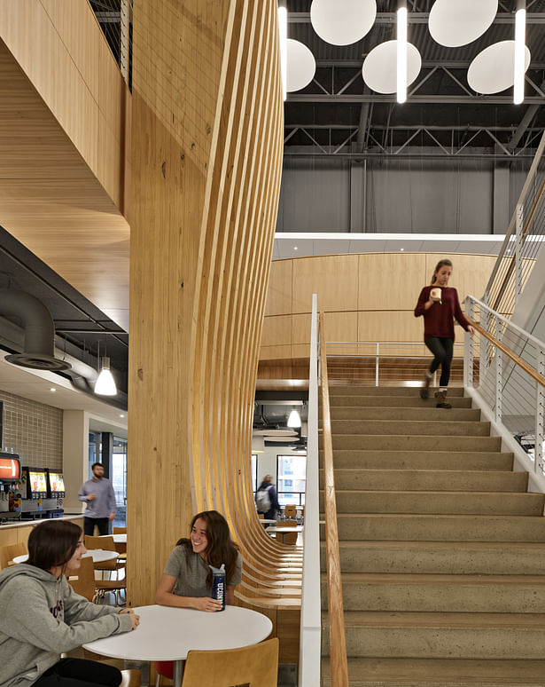The iconic wood sculpture and open stair unites the overall design.