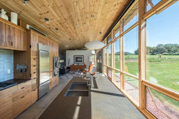 View of the kitchen with living room and master suite beyond. photo:Fredrik Brauer