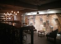 Old-world inspired glass encased wine cellar and tasting lounge.