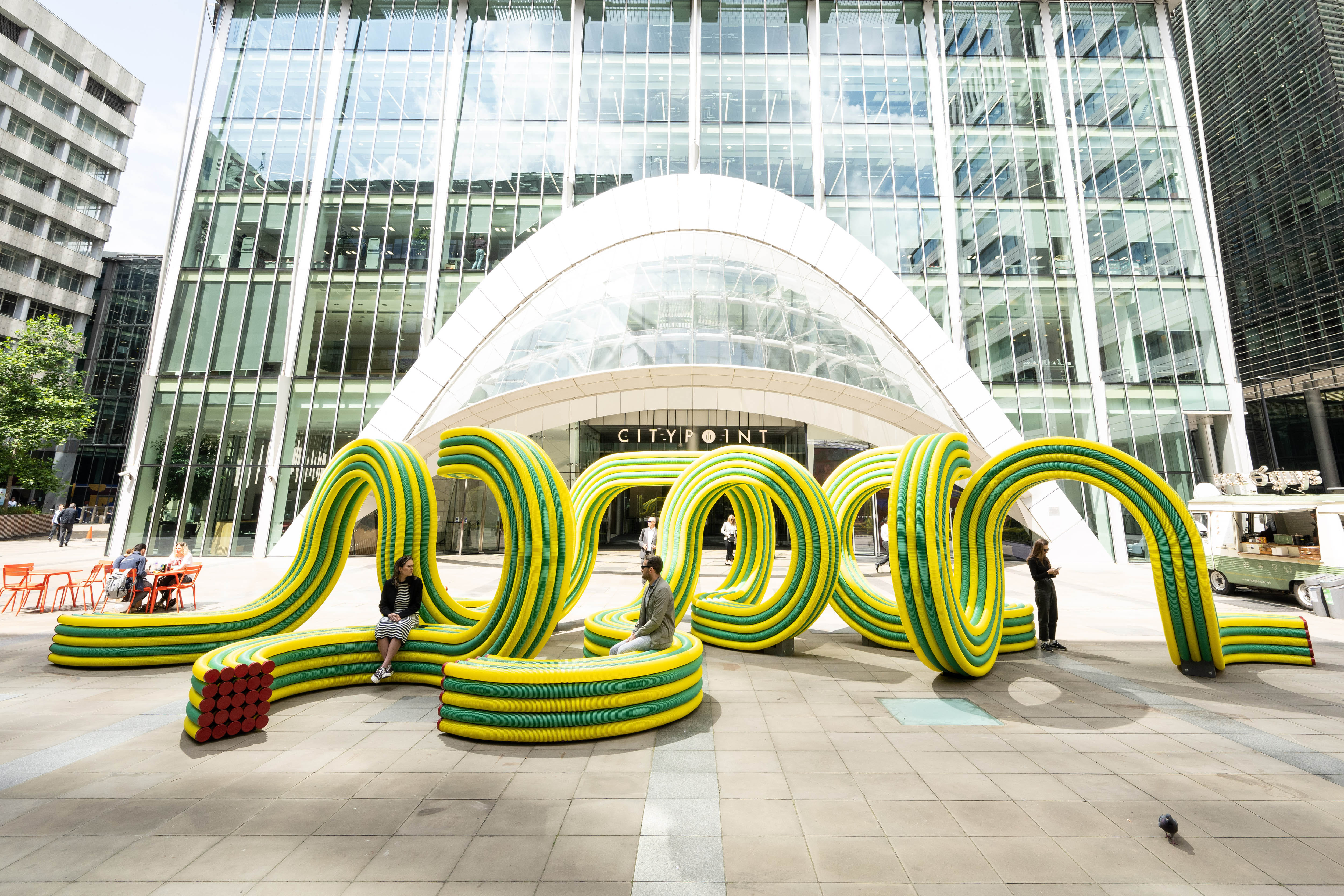 Vibrant pavilions by Foster + Partners and NEON utilize recycled everyday materials