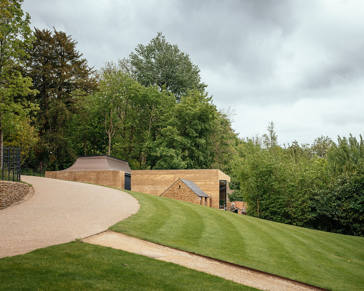 Invisible Studio creates rammed stone yoga studio in UK countryside