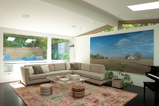 Living room, with large windows looking out to the rear gardens and pool.