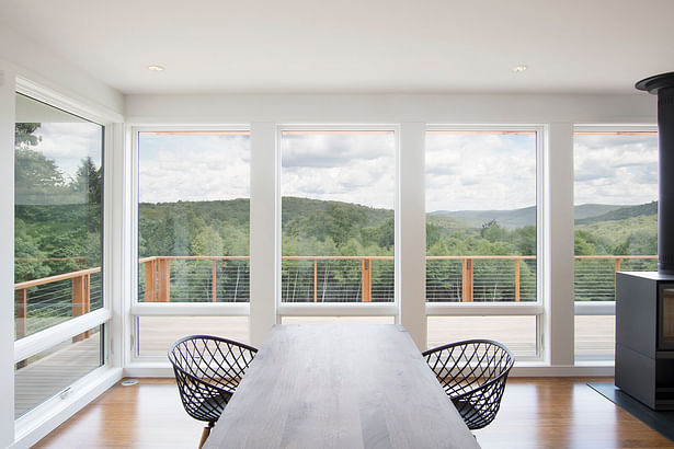 Open living, dining, kitchen space gets panoramic views for a relatively modest home.