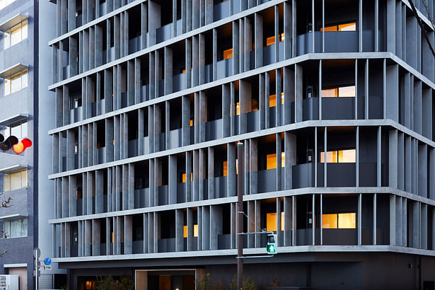 The building is wrapped in concrete fins