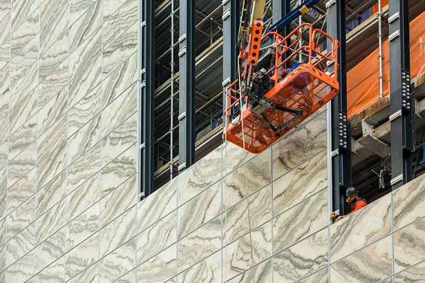 Facade stone-glass panels install Oct 2021; photo by Aaron Thompson