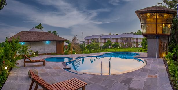 Pool with conference on left and guest rooms in the front.