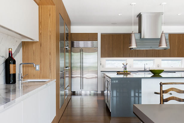 Open Kitchen with Large Central Island and Teak Cabinetry