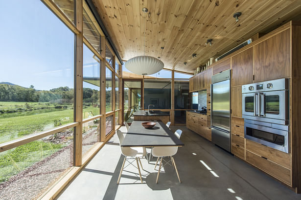 A view of the kitchen looking west to the dog trot and guest wing beyond photo: Fredrik Brauer