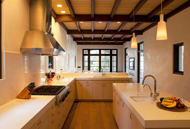 Kitchen details include flush overlay white oak cabinetry, 3 1/2 inch thick Caesarstone counters, and Wolf appliances. 