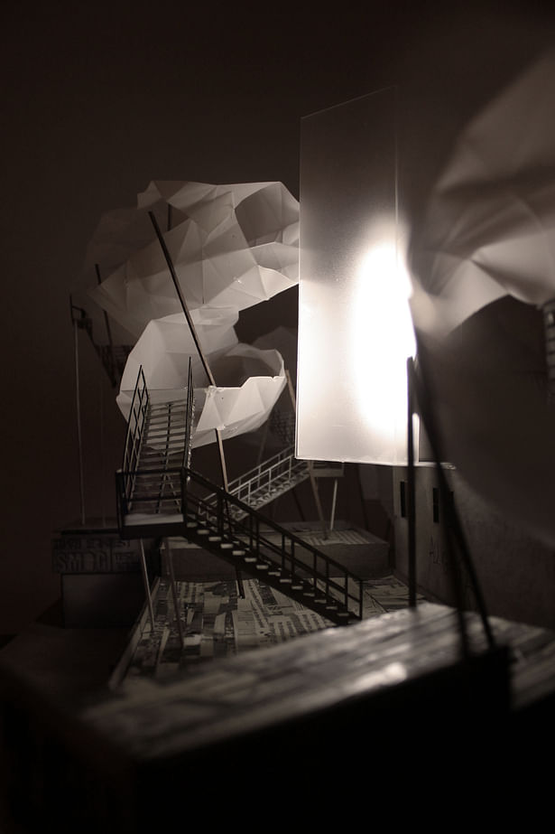 A view of the cloud forms which hover above the rooftops [photograph of physical model illuminated with LED lighting]