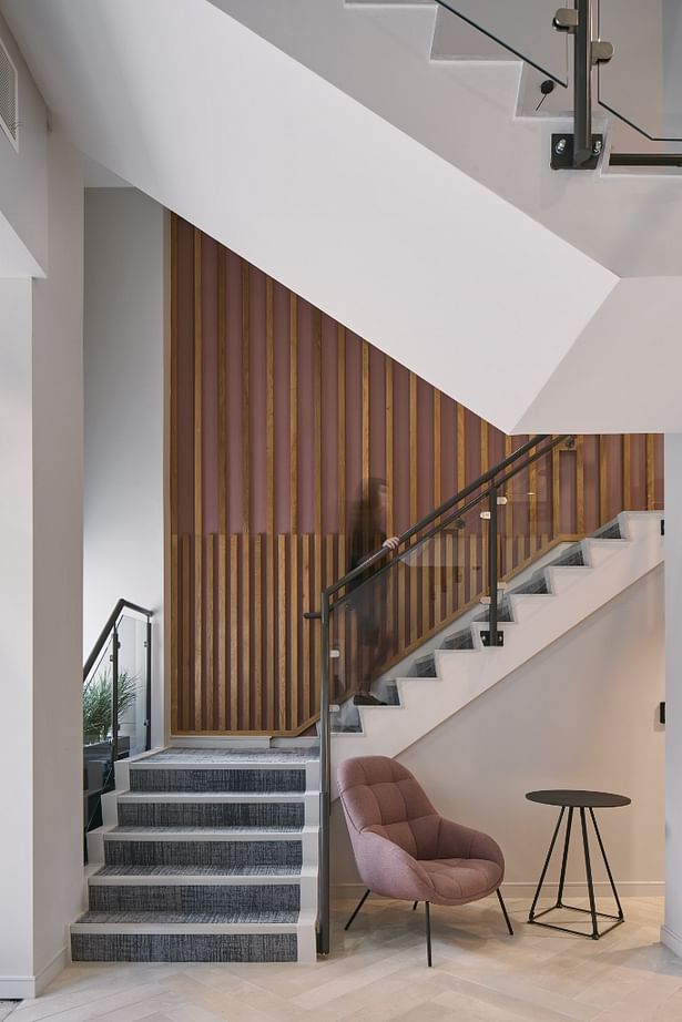 Bespoke feature wall alongside entrance lobby stair 